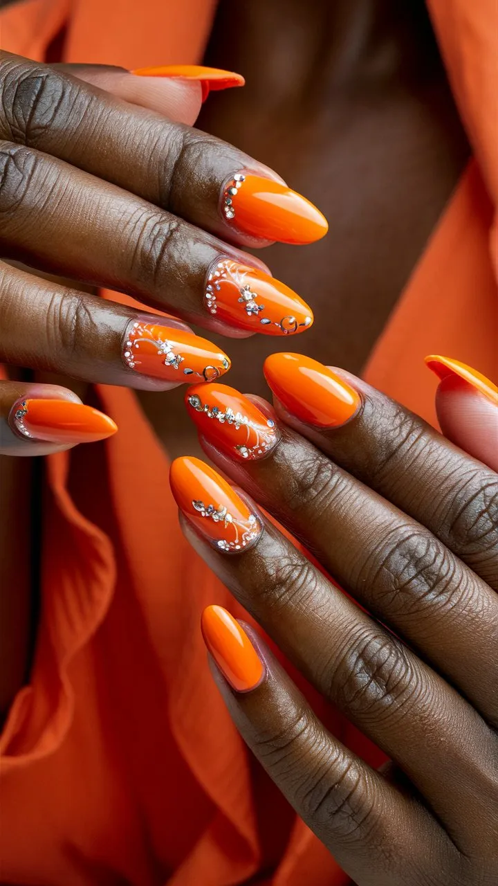 Vibrant orange nail colors, brightening up the appearance with a bold and lively shade.