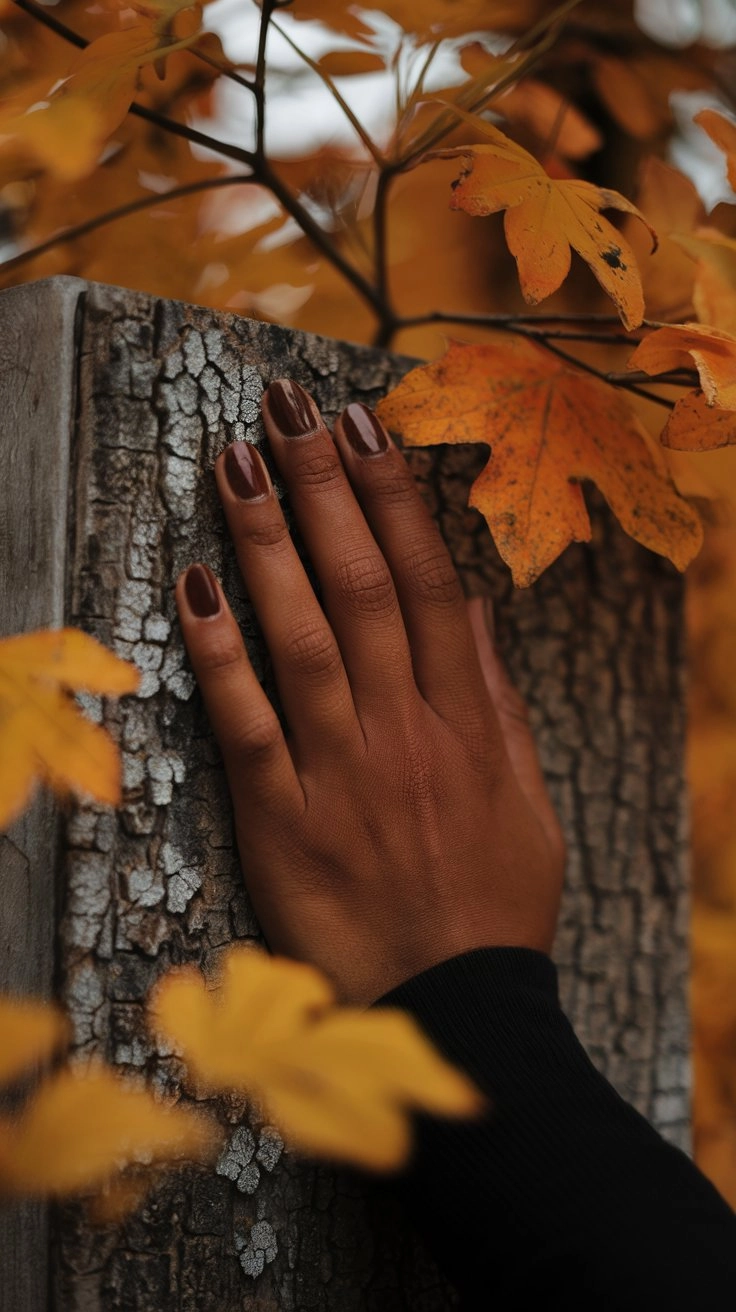 Close-up photo of warm chocolate brown nail polish, highlighting its rich color and glossy finish, elegantly displayed on a neutral background.