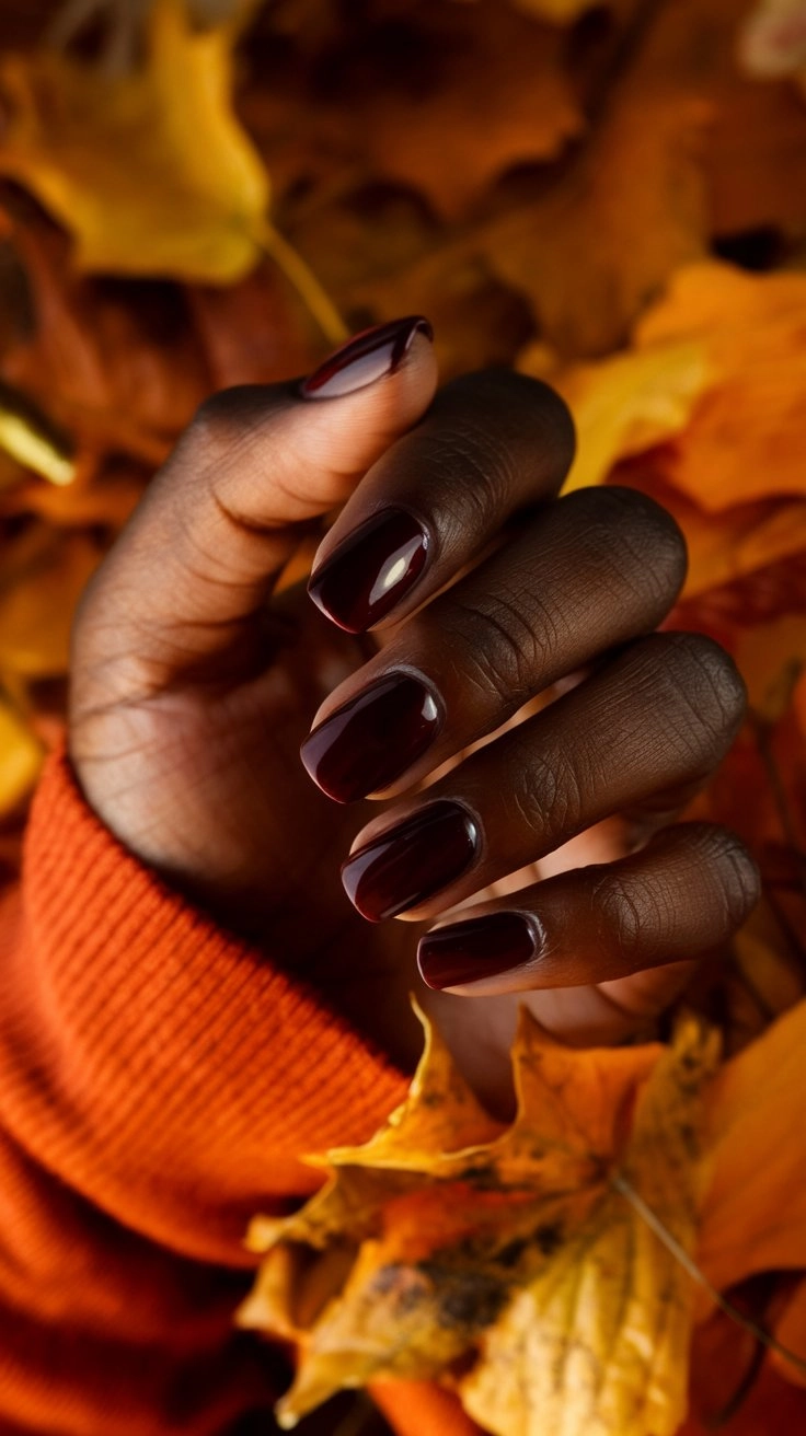 Close-up of deep burgundy nails with a glossy finish, showcasing their elegance