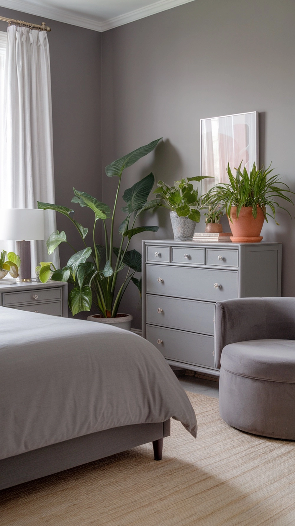 Grey bedroom with green plants adding life and color