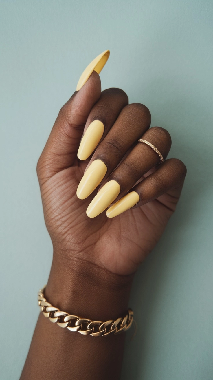 Close-up of hands showing butter yellow nails with nail polish bottles