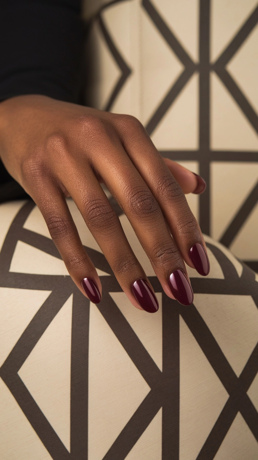 How to Style Burgundy Nail Designs for a Bold Stunning Look 10 A hand displaying burgundy nails in a French manicure style