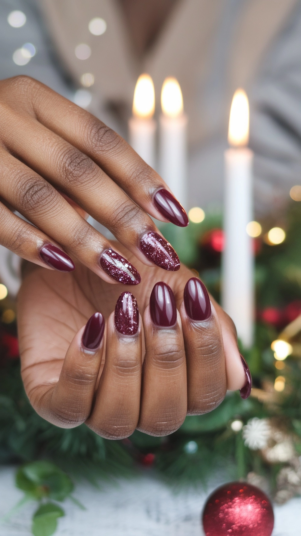 How to Style Burgundy Nail Designs for a Bold Stunning Look 20 A close-up of beautifully manicured burgundy nails with a mix of glossy and glitter finishes, set against a festive background.