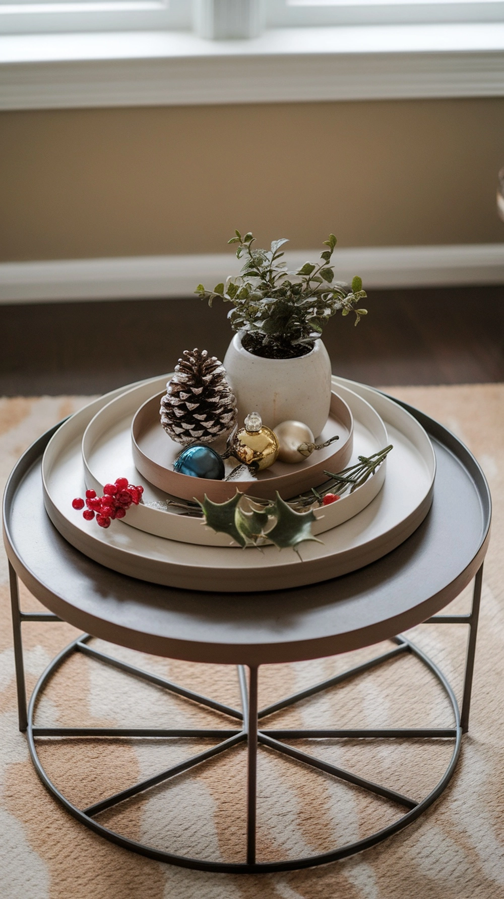 17 Cozy Coffee Table Fall Decor Ideas to Warm Your Home 20 A layered tray on a coffee table featuring a small plant, pine cone, and colorful ornaments, showcasing fall decor.