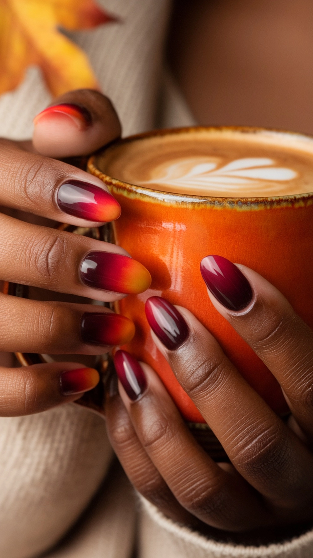 How to Create the Perfect Fall Ombre Nails at Home 2 Hand holding a mug, showing burgundy to orange fall ombre nails.