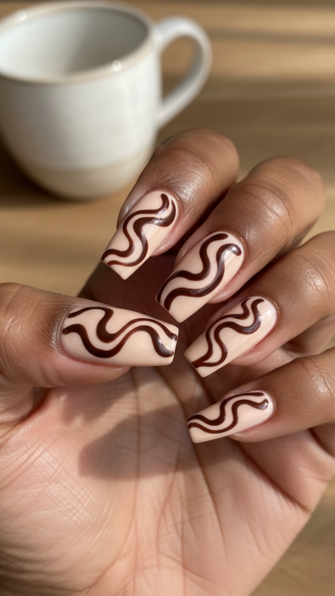 25 Jaw-Dropping Fall Nail Ideas You Must Try 10 Long coffin nails featuring a retro swirl design in chocolate brown and beige.
