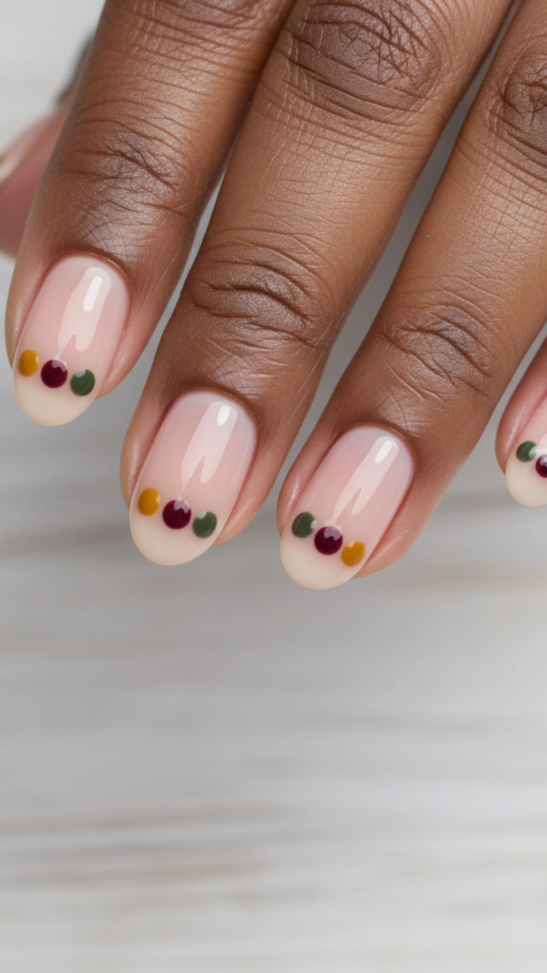 25 Jaw-Dropping Fall Nail Ideas You Must Try 9 A minimalist nude manicure decorated with small dots in fall colors.