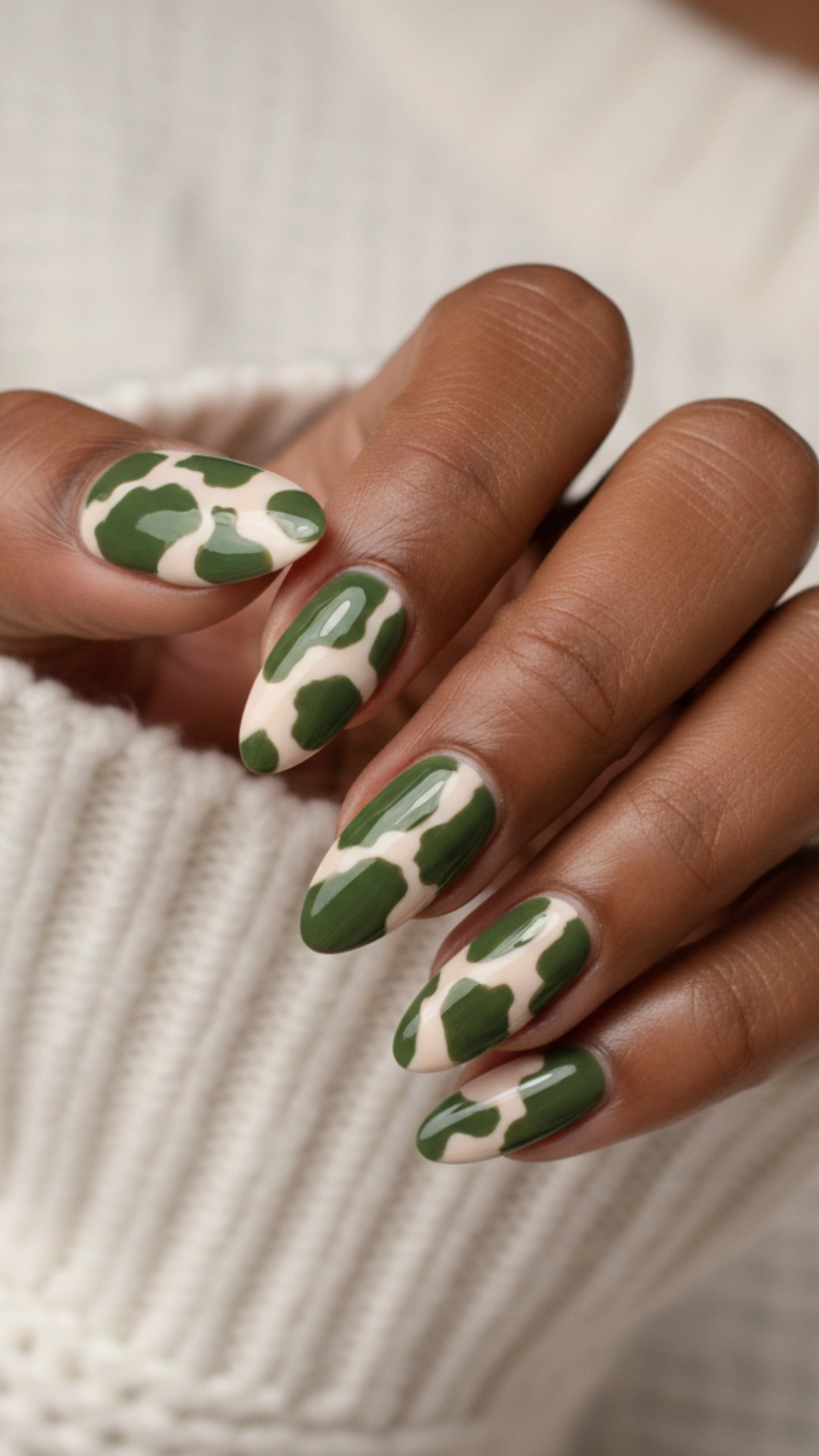 25 Jaw-Dropping Fall Nail Ideas You Must Try 22 Abstract nail art featuring bold olive green shapes on a cream-colored background.