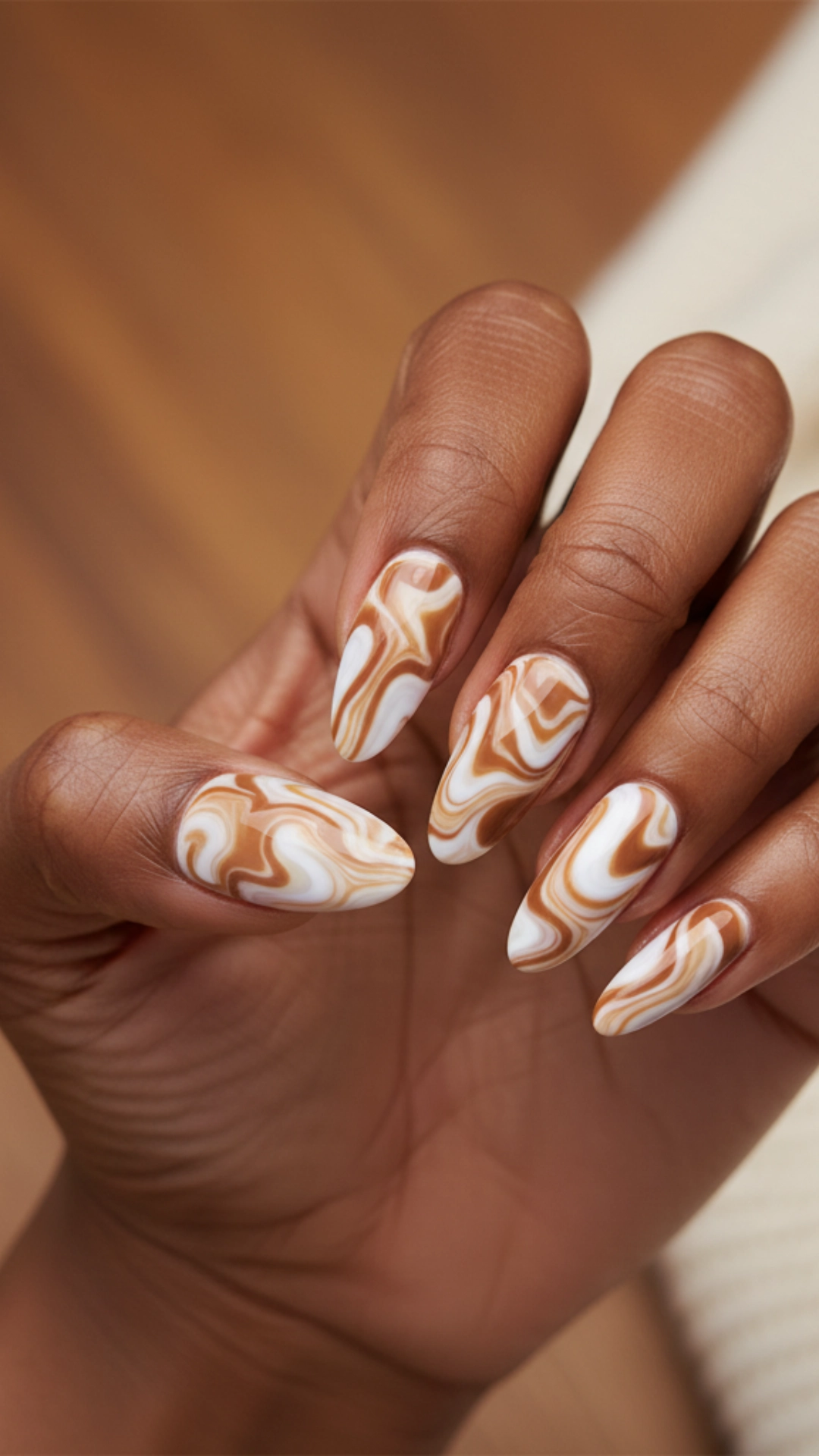 25 Jaw-Dropping Fall Nail Ideas You Must Try 23 A detailed water marble nail design that looks like swirled toffee candy.