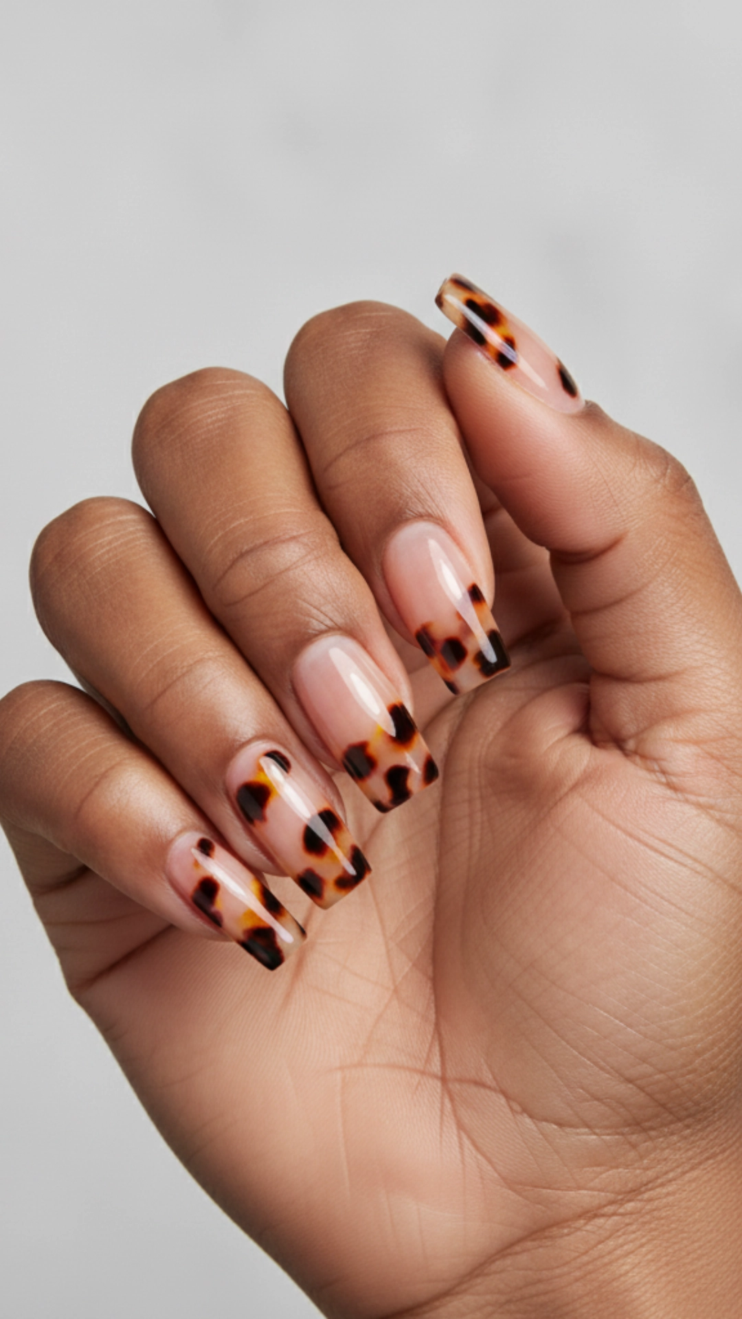 25 Jaw-Dropping Fall Nail Ideas You Must Try 6 A modern French manicure featuring a detailed tortoiseshell pattern on the tips.
