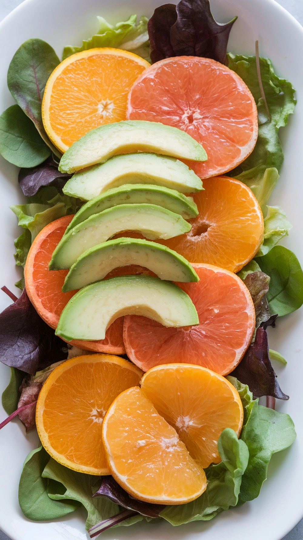 10 Thanksgiving Salad Recipes to Brighten Up the Table 11 A vibrant Winter Citrus Salad with slices of oranges, grapefruits, and avocado on a bed of greens.