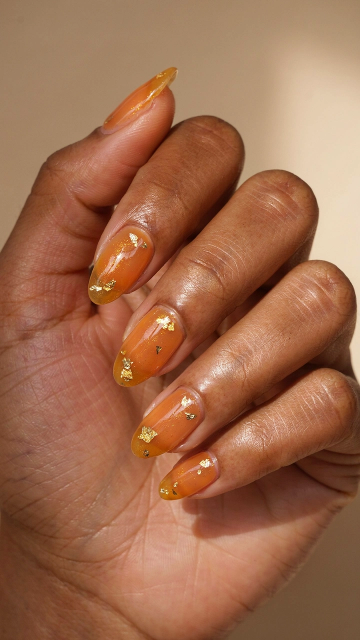 21 Cozy Fall Nail Ideas for a Warm Seasonal Look 12 Shimmering amber gel nails with gold foil.