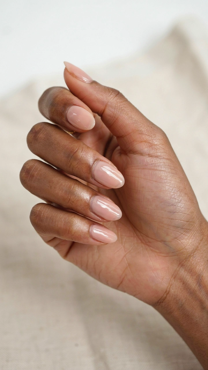 Hand displaying toasted marshmallow nude nail polish.